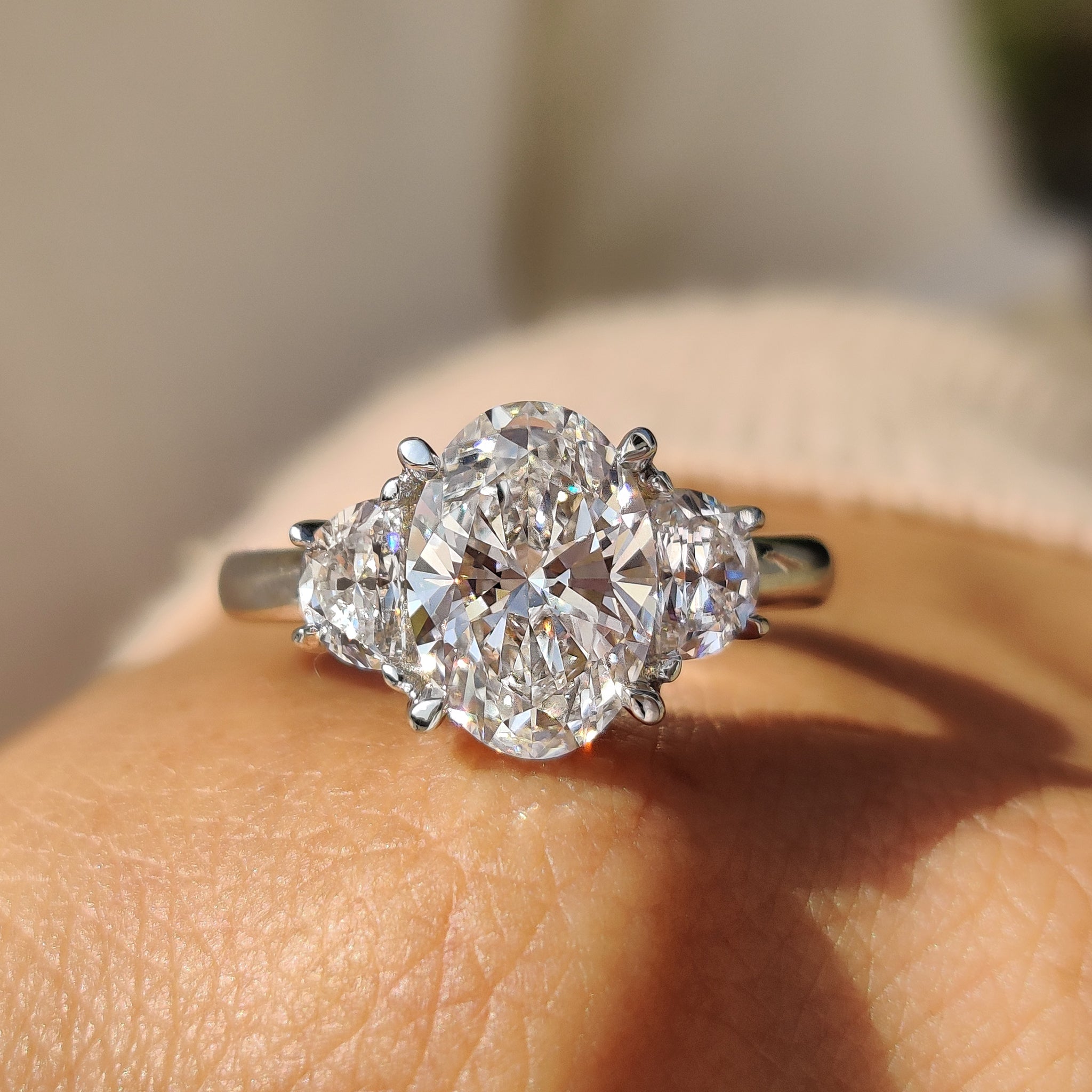 Oval Cut Diamond Engagement Ring With Half Moon Side Stone