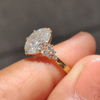 Oval Diamond Ring With Round Cut Side Stone
