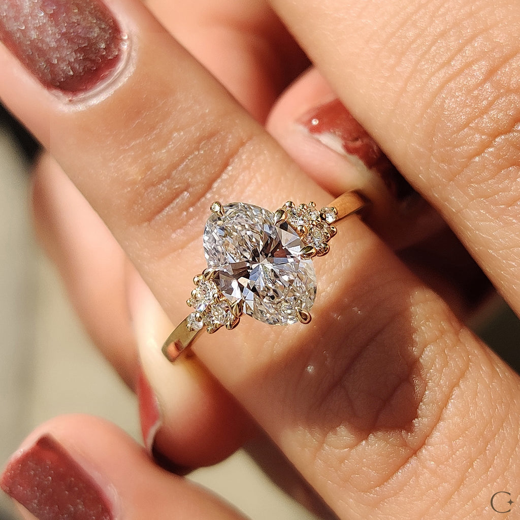 Oval Diamond Ring With Round Cut Side Stone