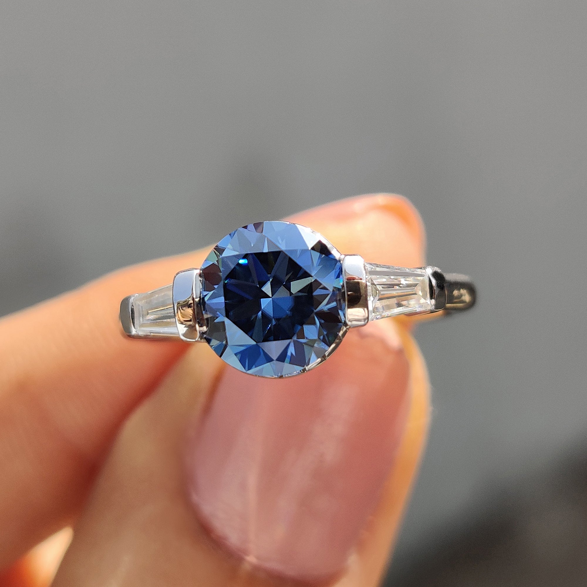 Round And Tapered Baguette Three Stone Engagement Ring