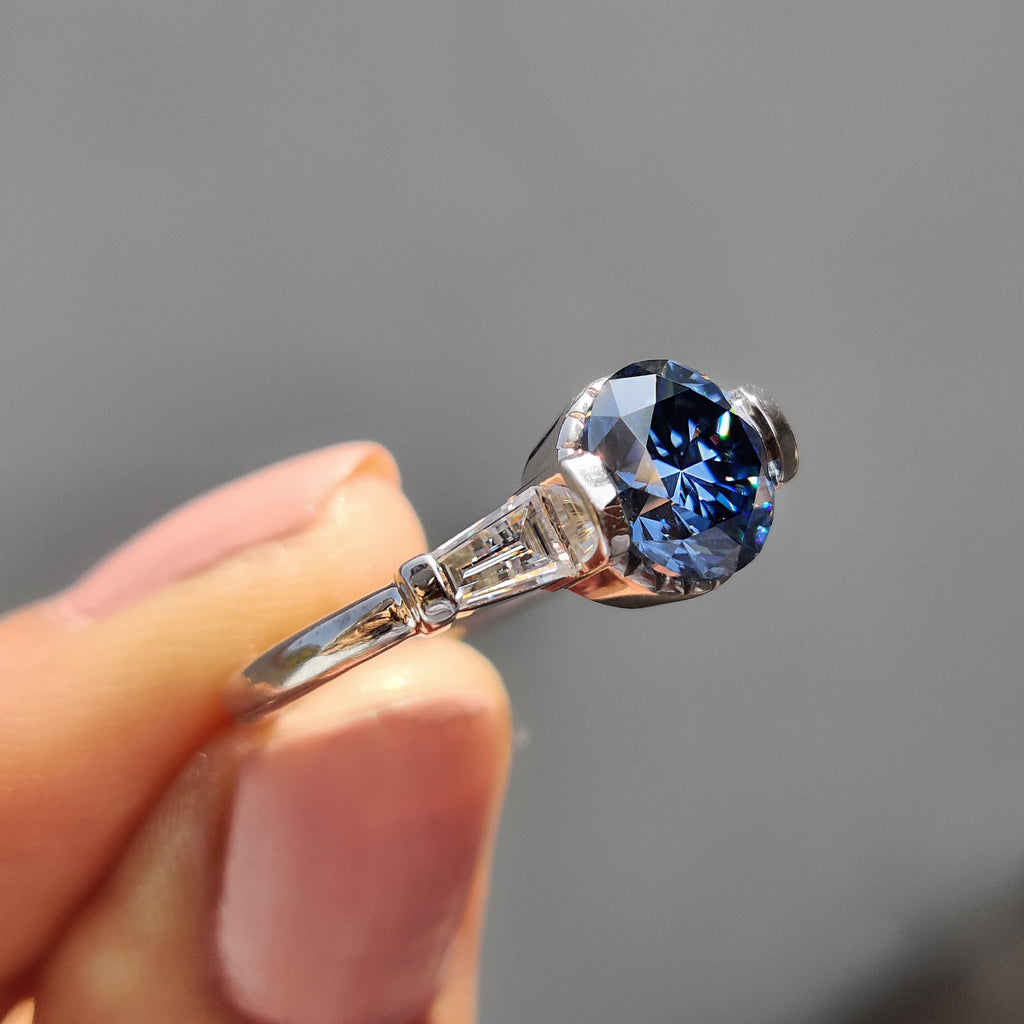 Round And Tapered Baguette Three Stone Engagement Ring