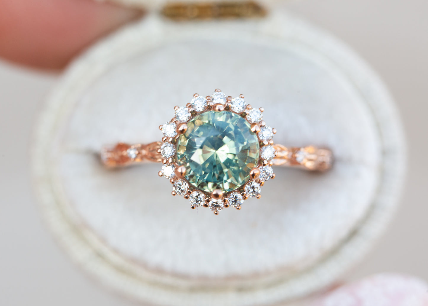 Egwene setting with round teal sapphire engagement rings | floral rings