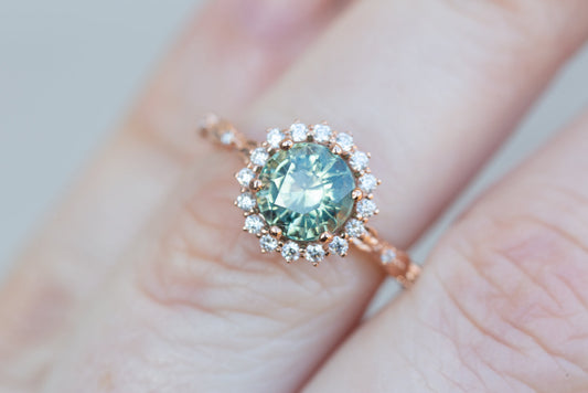 Egwene setting with round teal sapphire engagement rings | floral rings