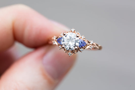 rose three stone with round moissanite and tanzanite engagement rings