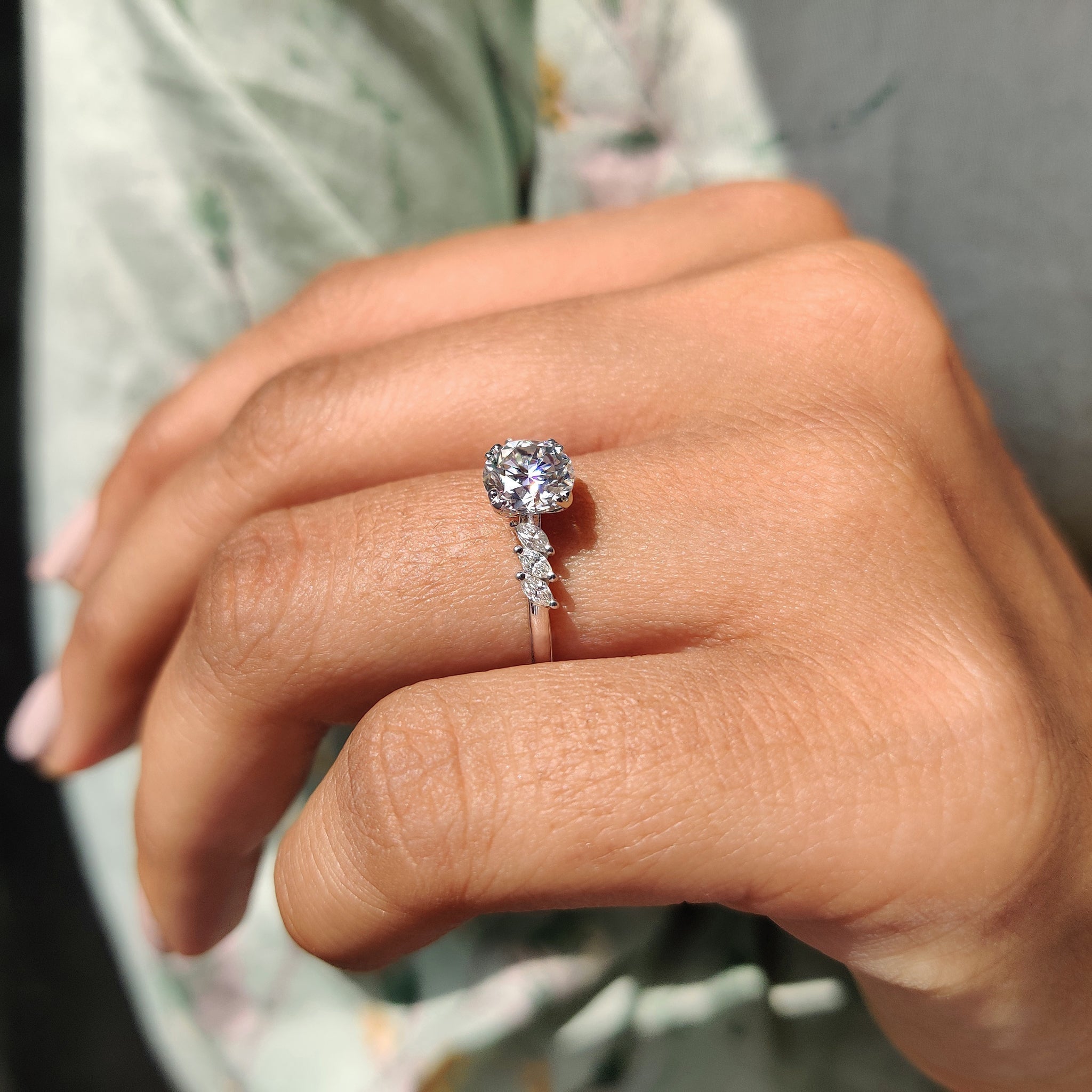 side stone engagement ring with round and marquise cut