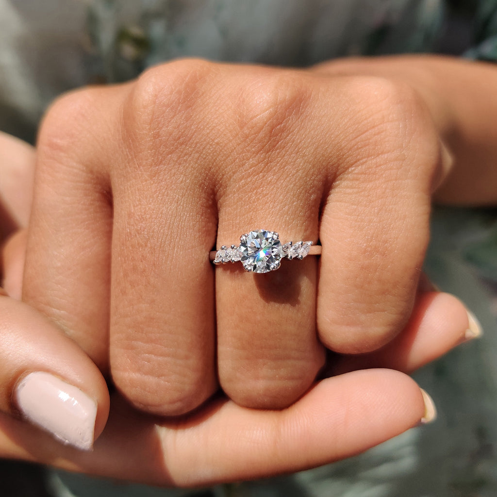 side stone engagement ring with round and marquise cut