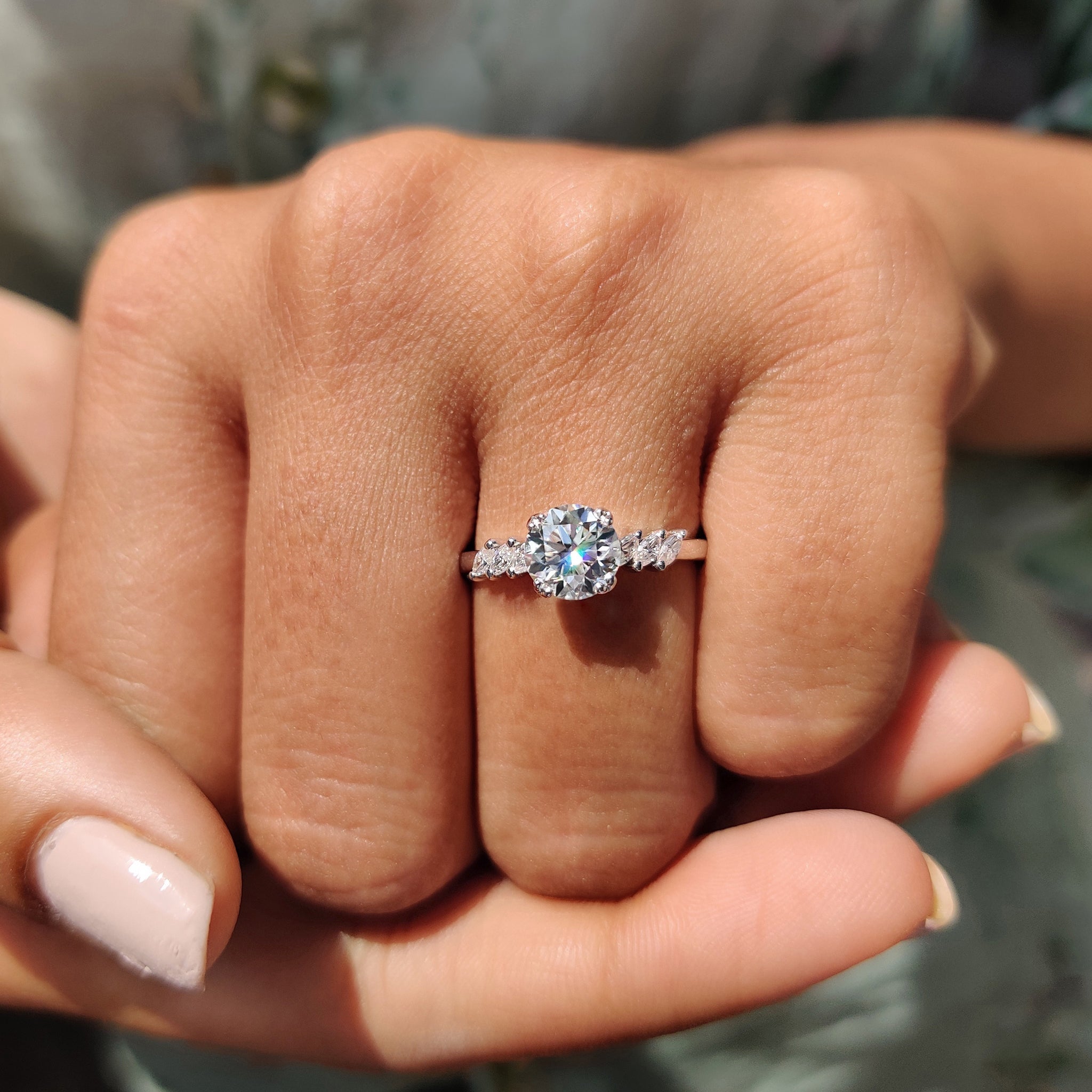 side stone engagement ring with round and marquise cut