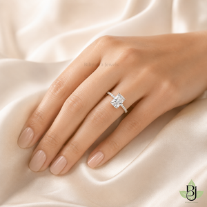 "uploaded  ring worn on a woman's finger, hand resting gracefully on a pure ivory satin fabric, lifestyle jewelry photography. ensured the product design and diamond perfectly match the reference file provided. Image Quality 2000 x 2000 pixel."