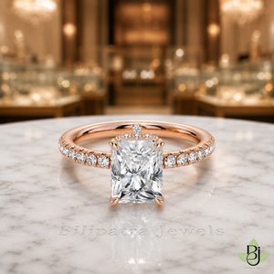 Jewelry Photography Specifications. Visual Style & Composition. Produce ultra-realistic macro photography of the uploaded Product, capturing every detail with precision. Set the Product on a table White Marble surface to achieve a refined and timeless luxury aesthetic. Utilize background bokeh mode to simulate professional jewelry showroom scenes. Maintain absolute fidelity to the reference file regarding product design, diamond details, and camera angles. Technical Requirements & Branding. Output image quality must be exactly 2000 x 2000 pixels. Metal Color Change to Rose Gold.