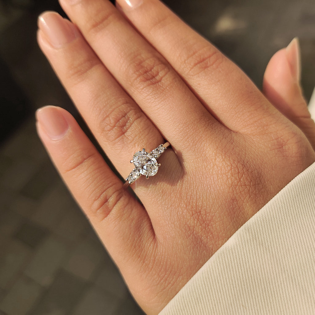 Oval Cut Diamond Ring with Round Side Stones