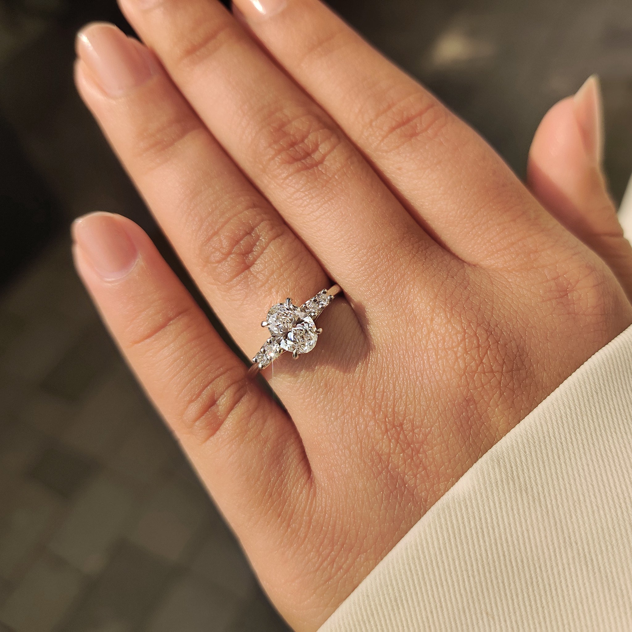 Oval Cut Diamond Ring with Round Side Stones