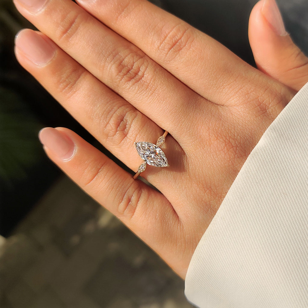 Marquise Cut Diamond Ring with Round Side Stones