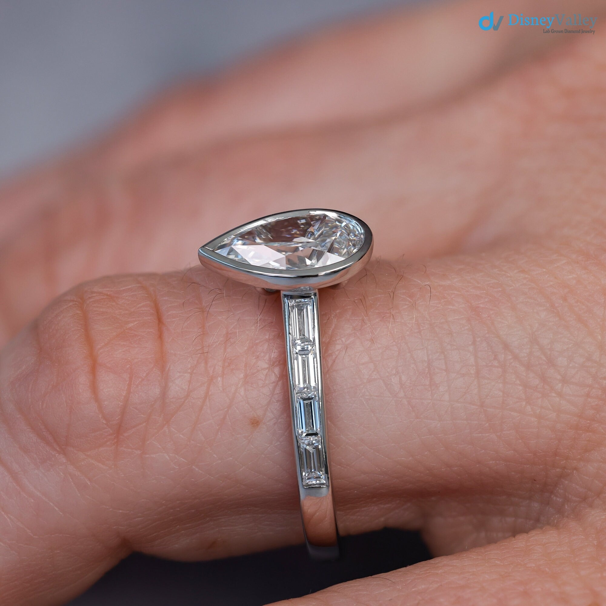 Pear Diamond Engagement Ring with Baguettes - Penelope: Bezel Set with Trellis and Channel Set - DisneyValley 
