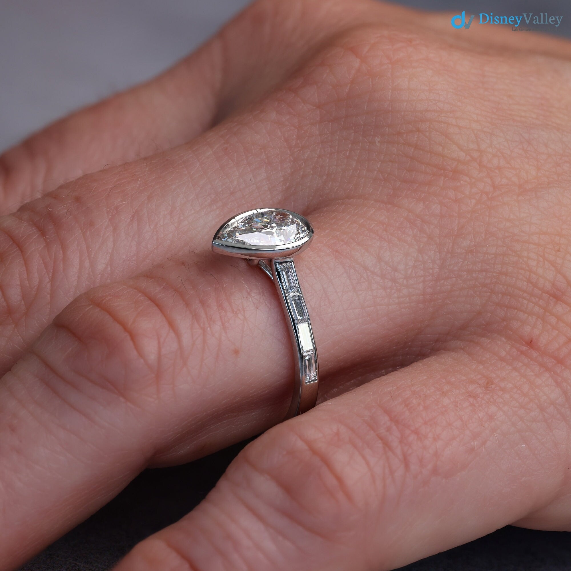 Pear Diamond Engagement Ring with Baguettes - Penelope: Bezel Set with Trellis and Channel Set - DisneyValley 