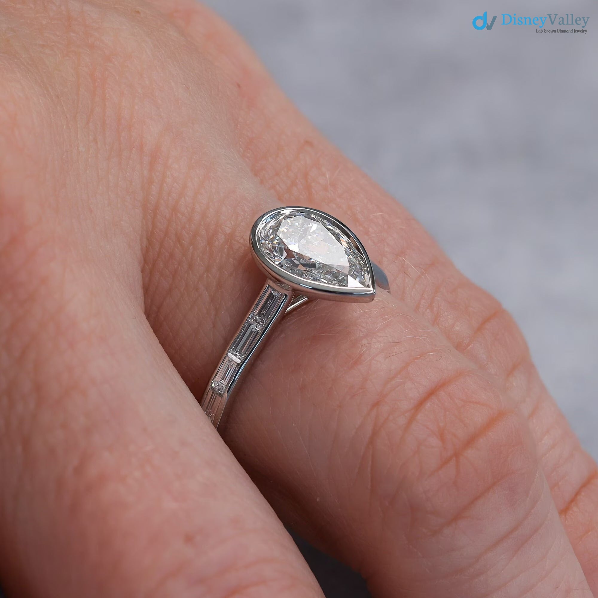 Pear Diamond Engagement Ring with Baguettes - Penelope: Bezel Set with Trellis and Channel Set - DisneyValley 