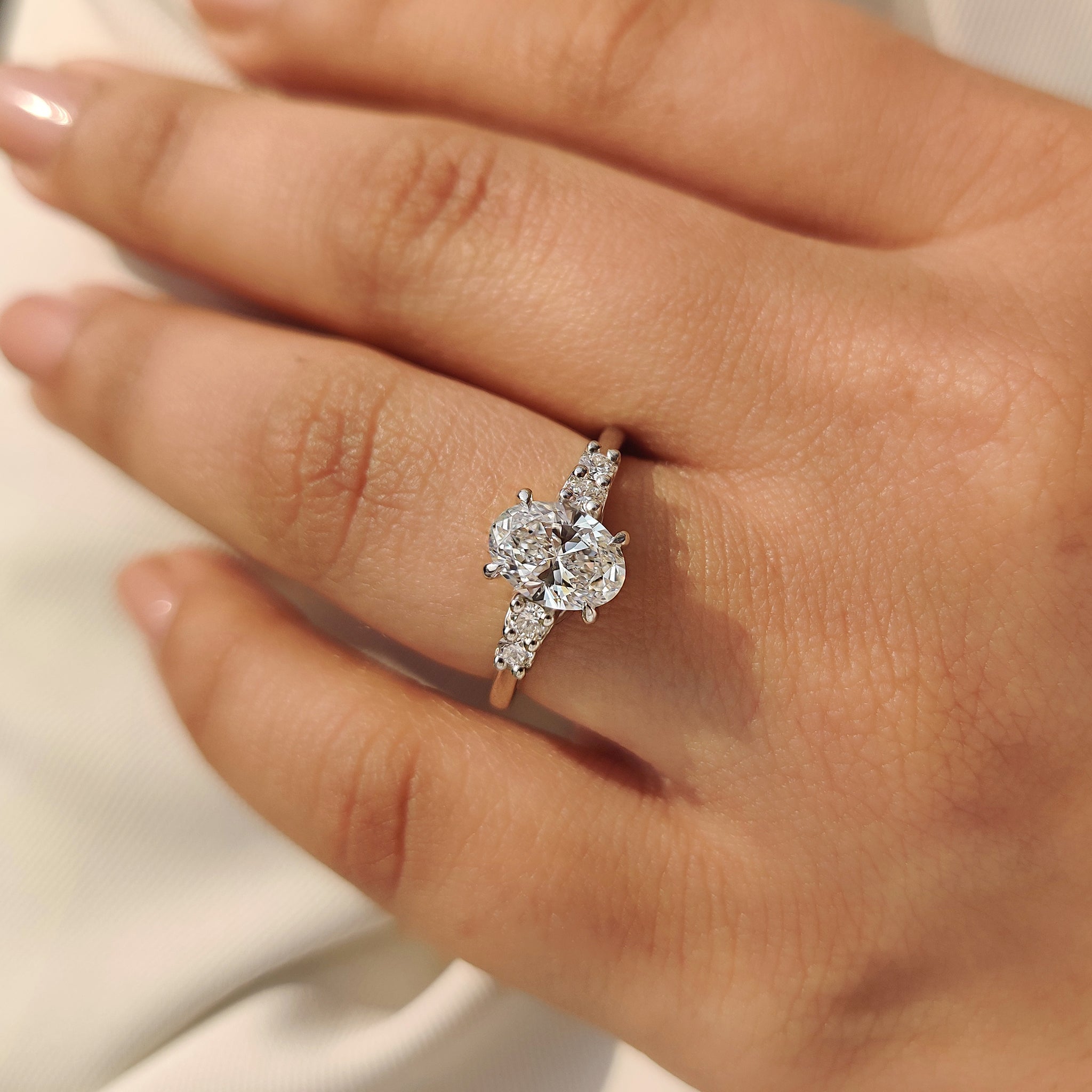 Oval Cut Diamond Ring with Round Side Stones