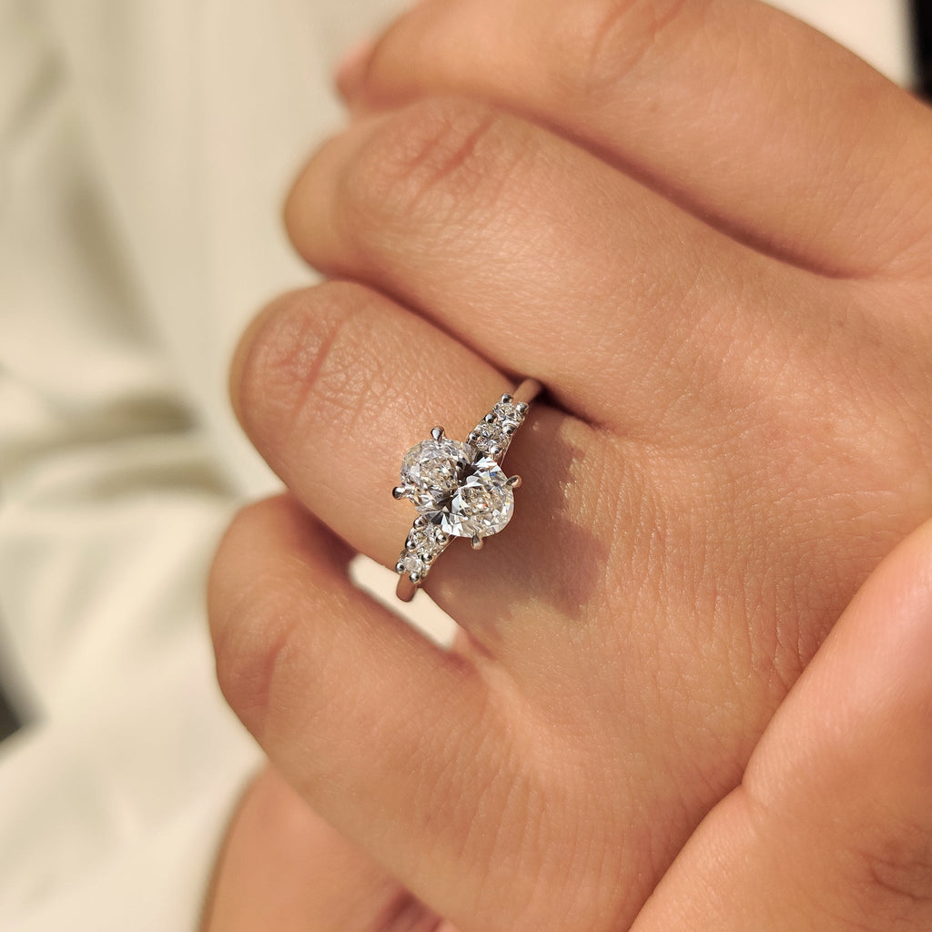 Oval Cut Diamond Ring with Round Side Stones