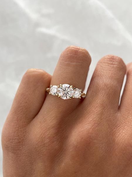 1.3ct round cut moissanite trilogy with twisted engagement rings