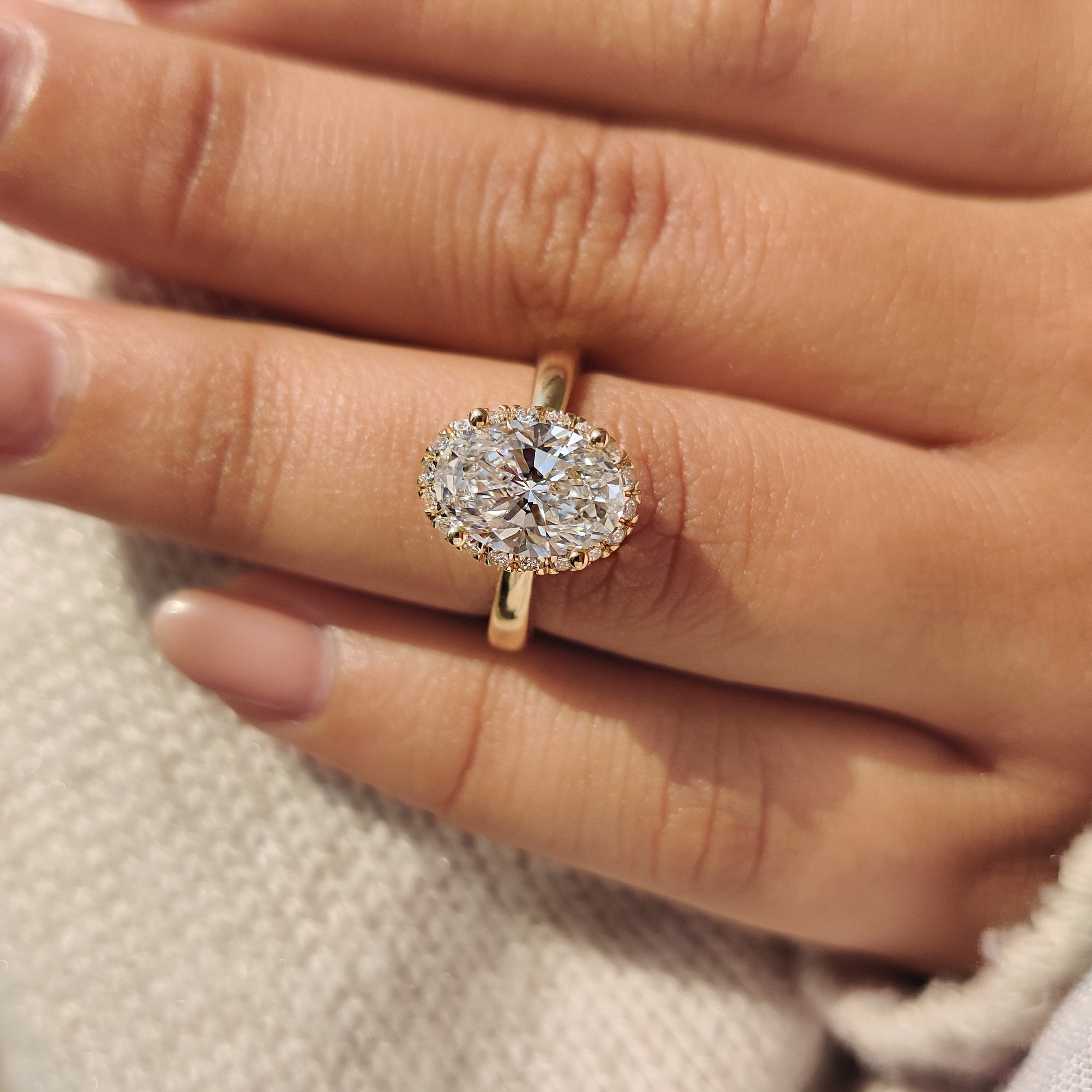 Oval Cut Diamond Ring in Round Cut Diamond Basket Setting