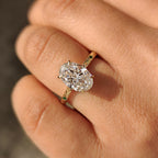 Oval Cut Art Deco Diamond Ring with Two Emerald Side Gemstones