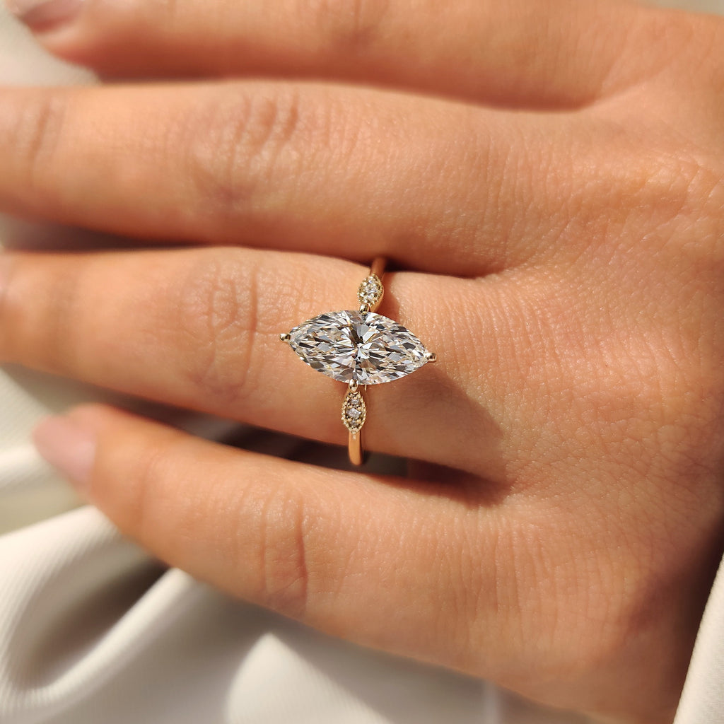 Marquise Cut Diamond Ring with Round Side Stones