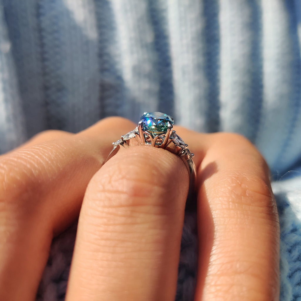Cyan Blue Moissanite Oval Side Stone Engagement Ring