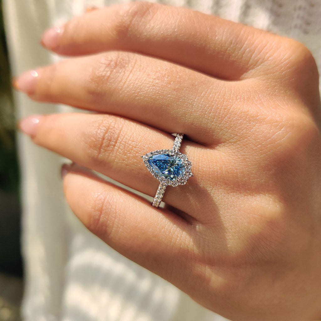 Cyan Blue Pear Diamond Ring In cathedral setting