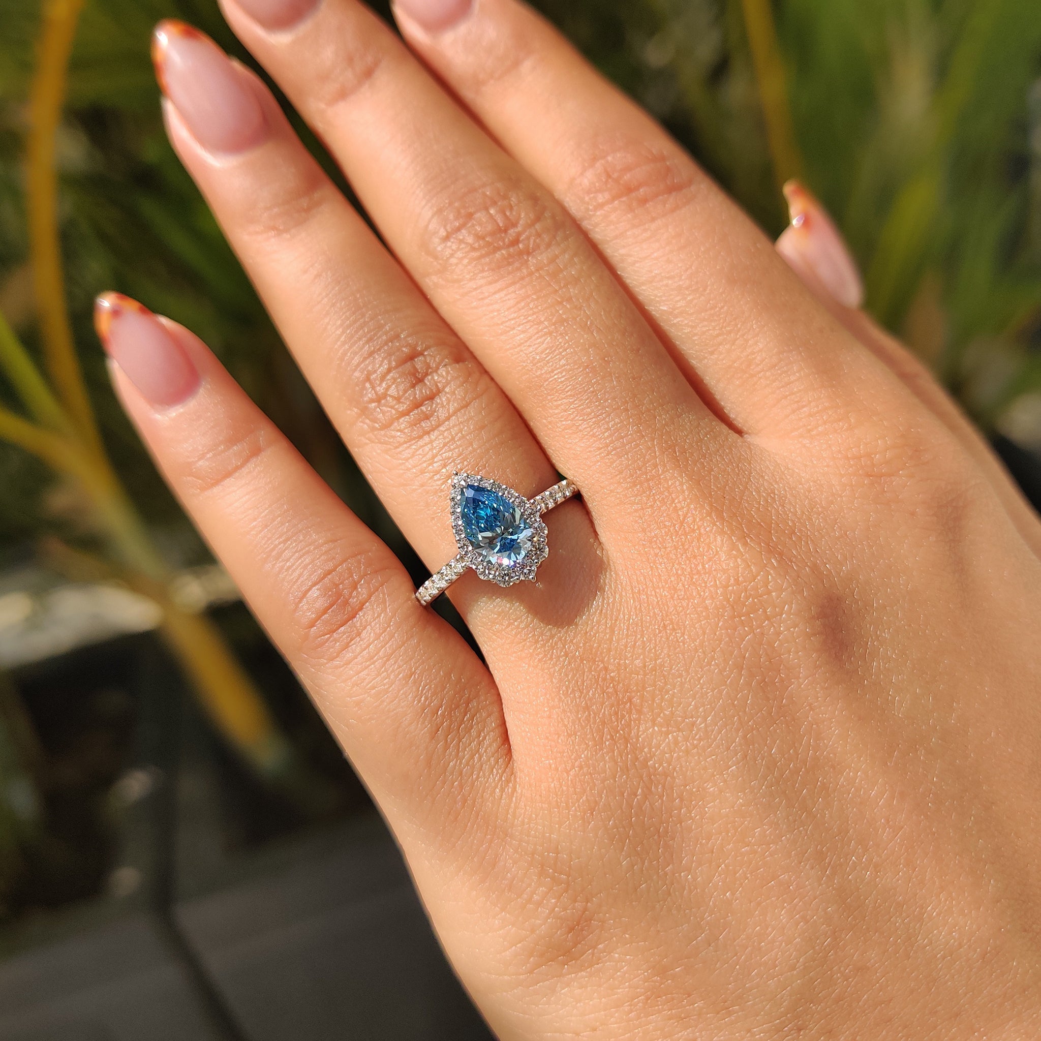 Cyan Blue Pear Diamond Ring In cathedral setting