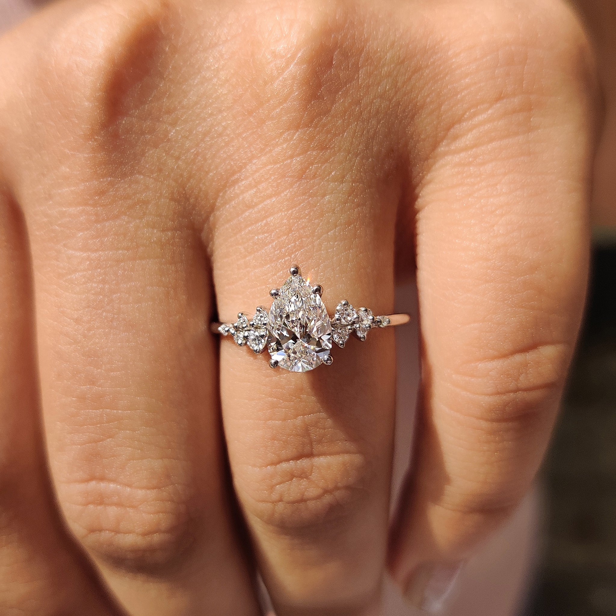 Pear Cluster Diamond Ring With Round Side Stone