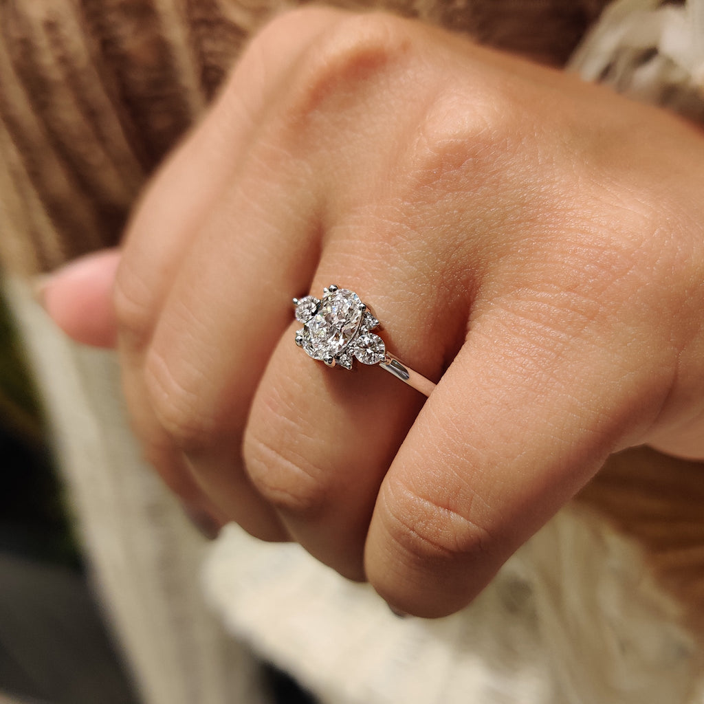 Oval Diamond Ring With Round Cut Side Stone