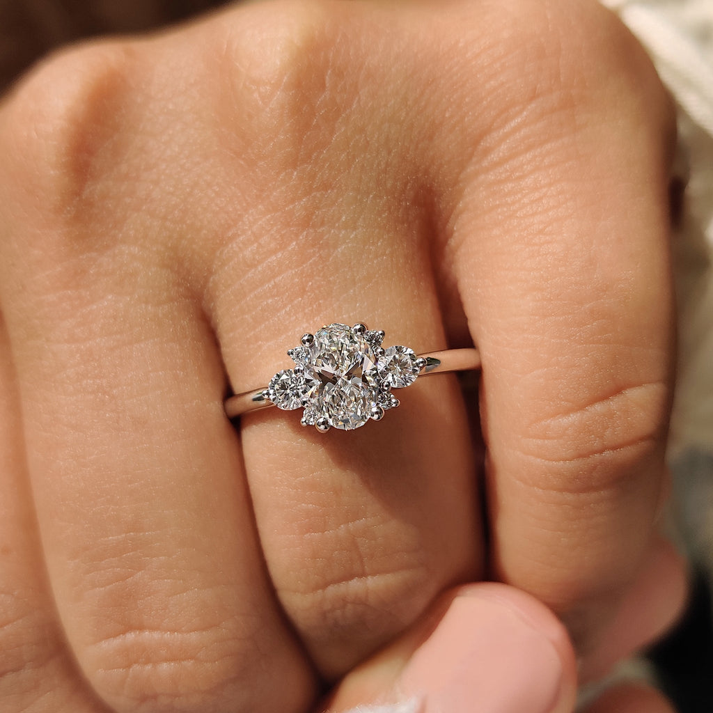 Oval Diamond Ring With Round Cut Side Stone