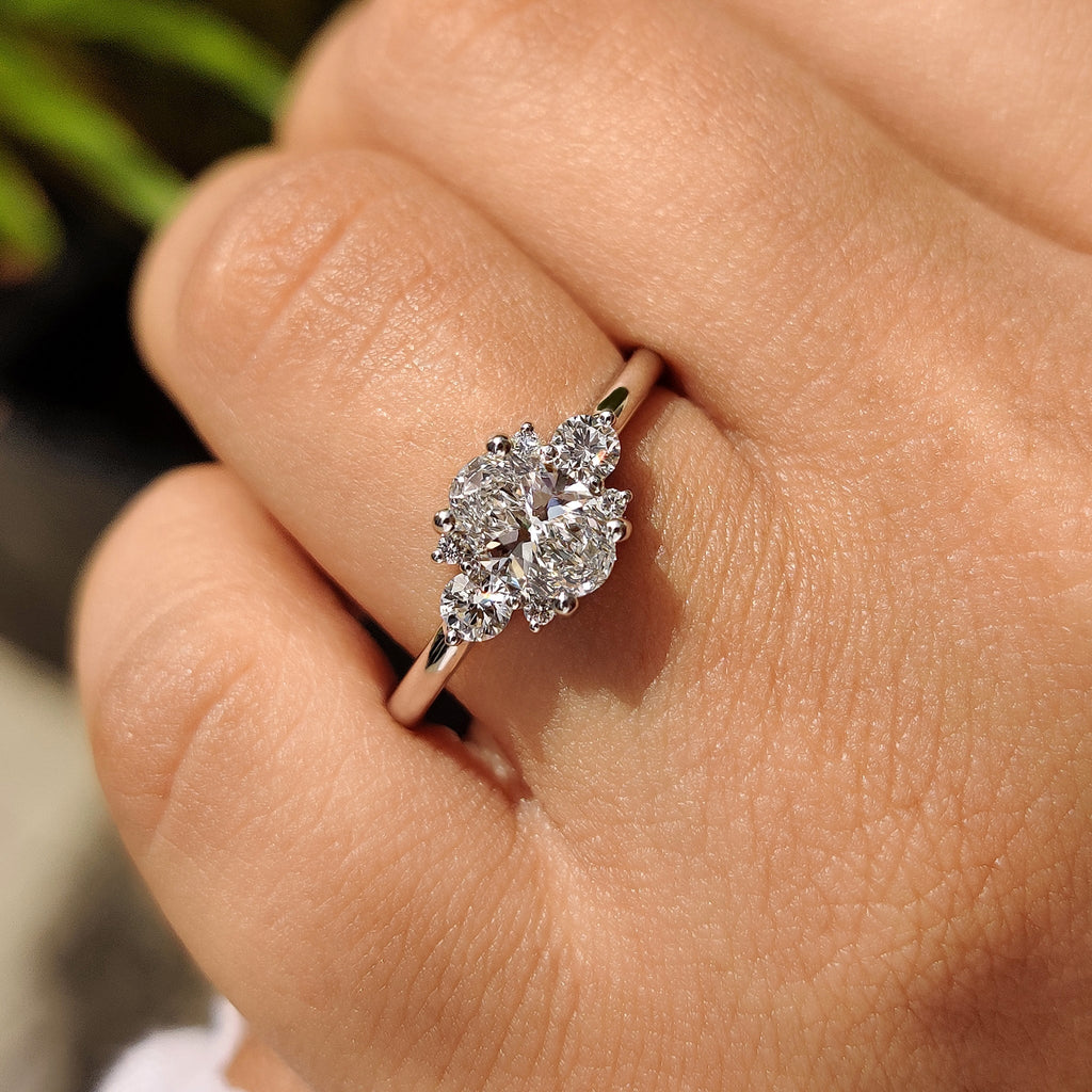 Oval Diamond Ring With Round Cut Side Stone