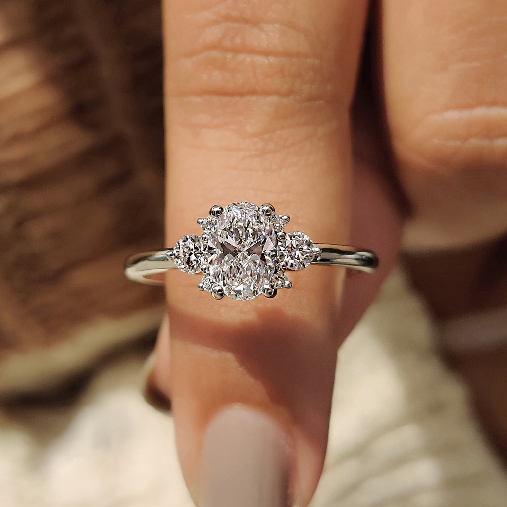 Oval Diamond Ring With Round Cut Side Stone