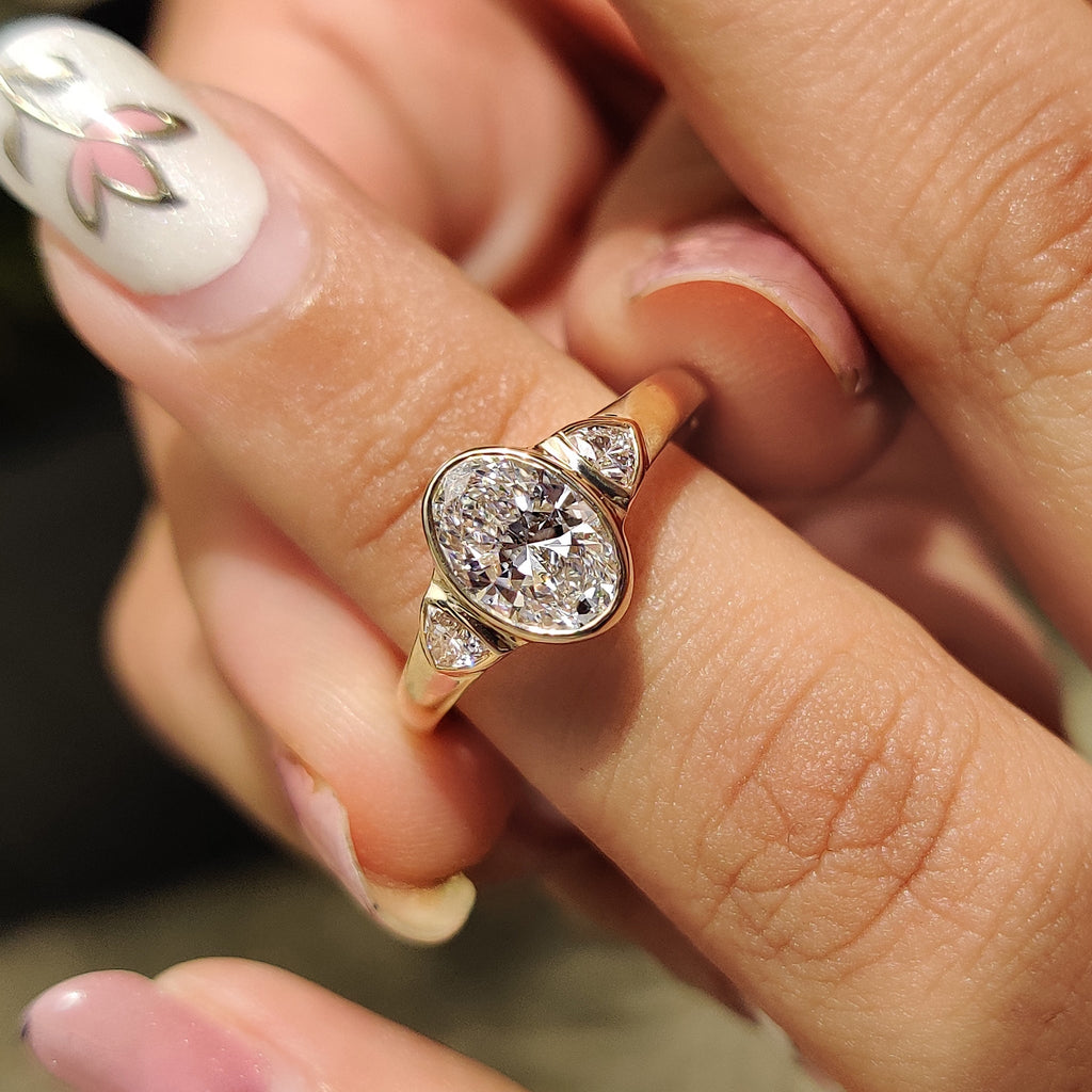 Oval Bezel Engagement Ring With Trillion Side Stone