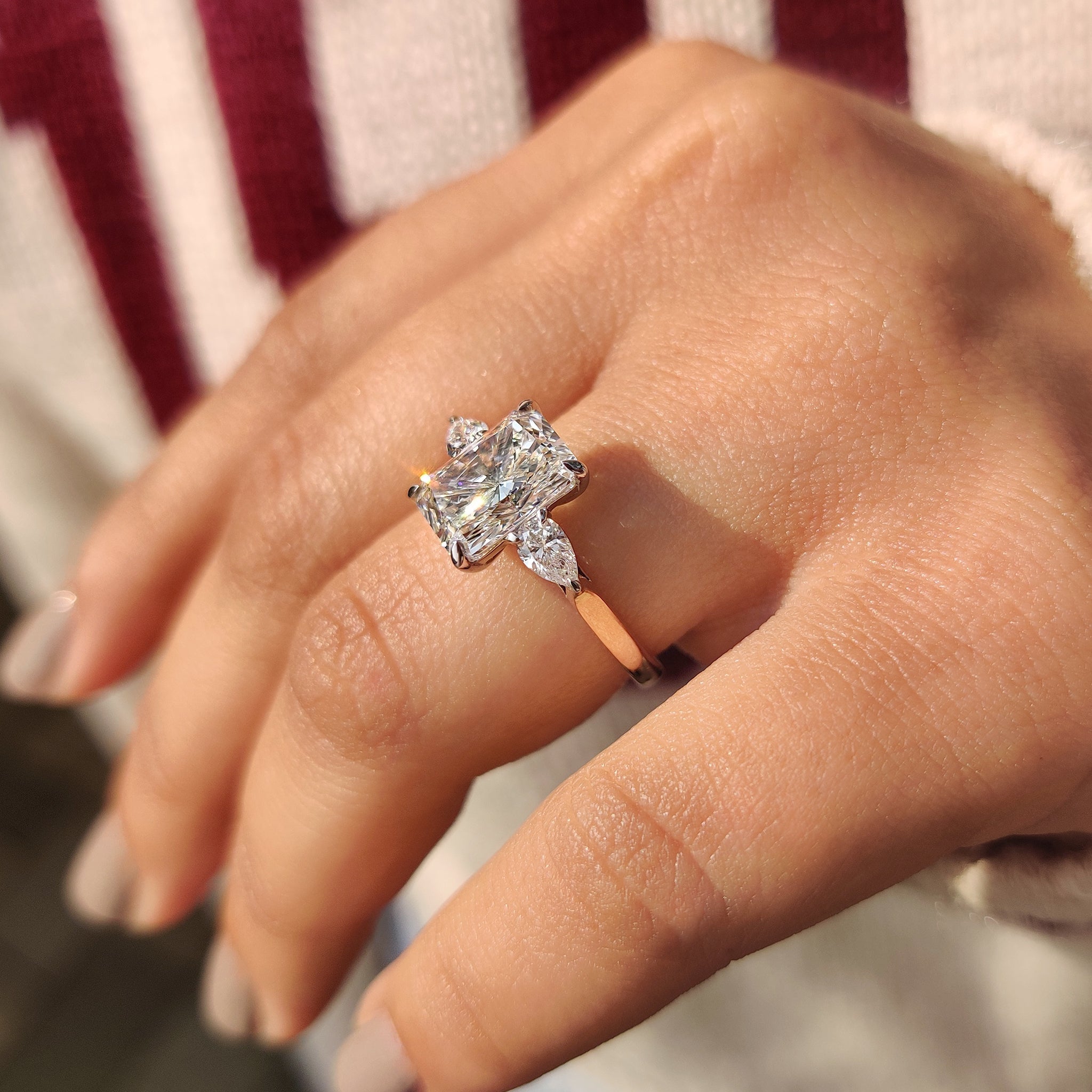 Two Tone Radiant Cut Diamond Ring With Pear Side Stones