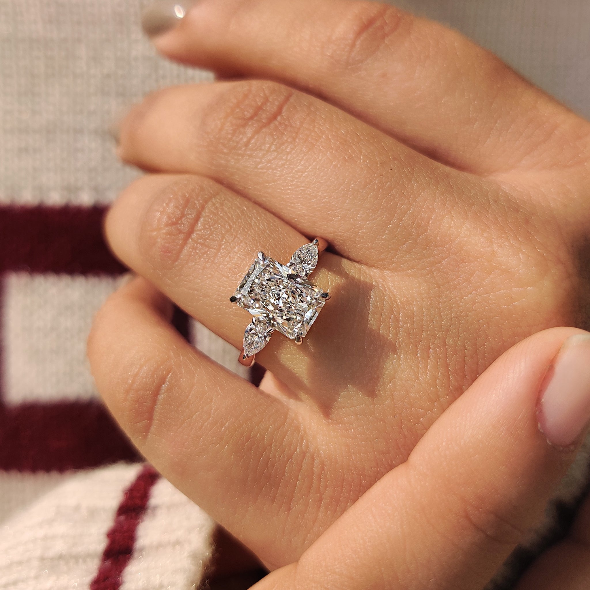 Two Tone Radiant Cut Diamond Ring With Pear Side Stones