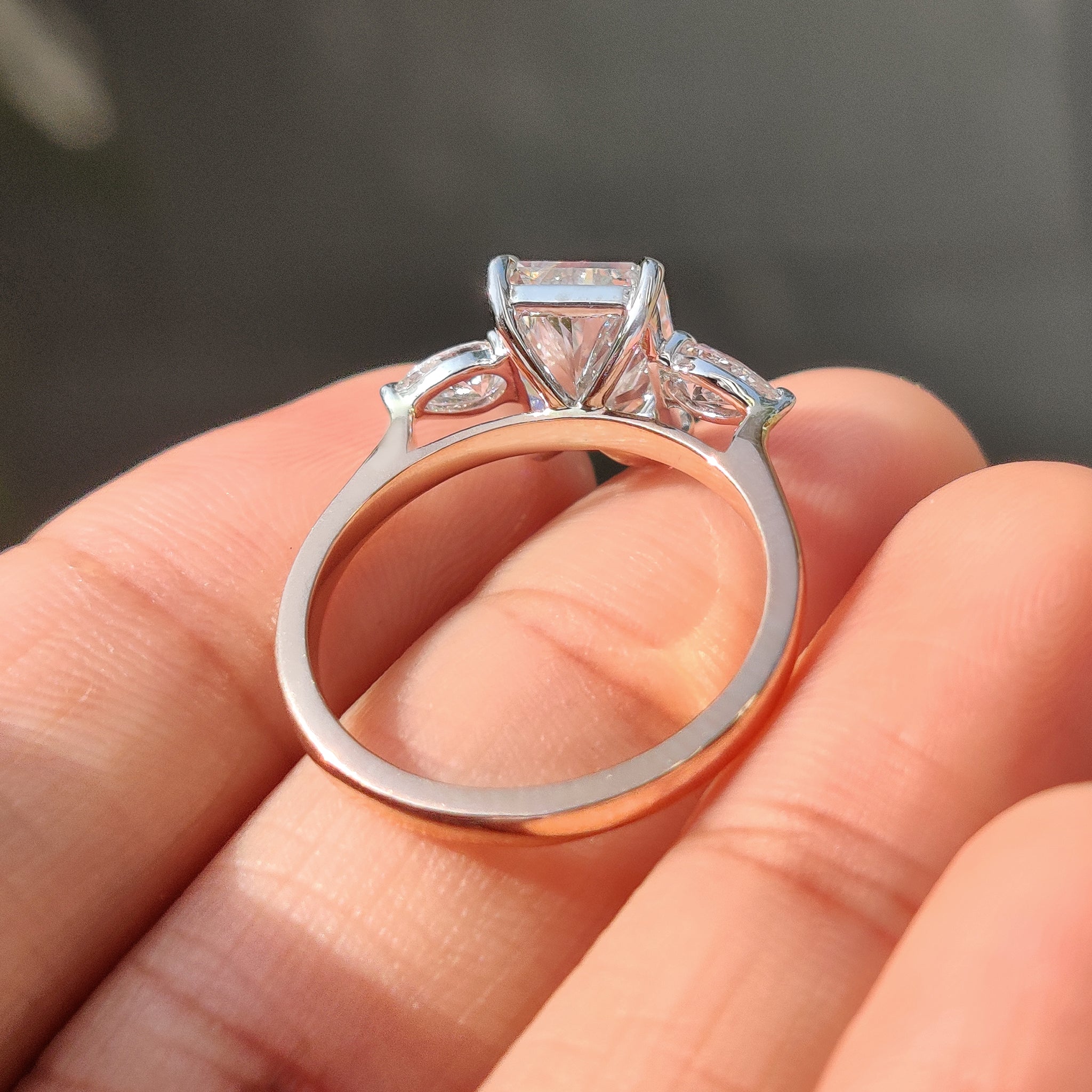 Two Tone Radiant Cut Diamond Ring With Pear Side Stones