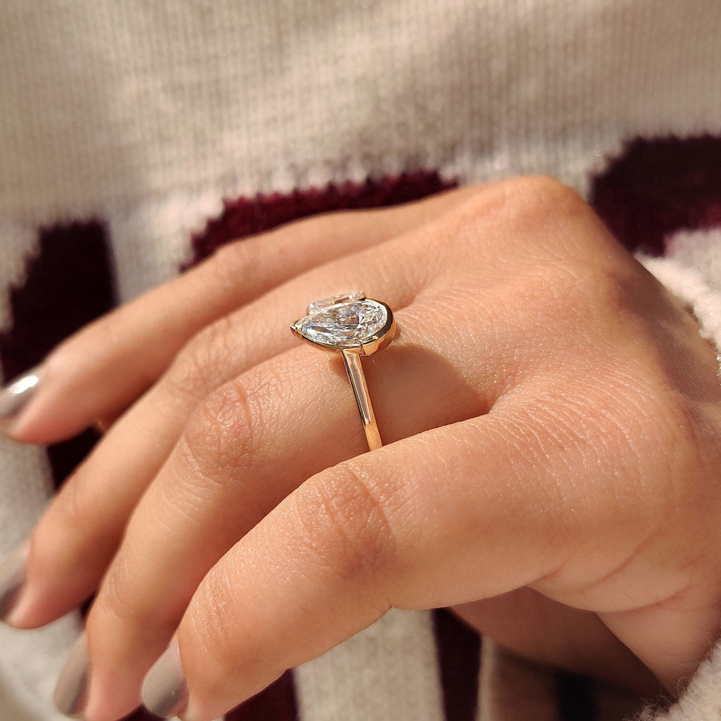 Emerald and Pear Cut Diamond Bezel Set Engagement Ring