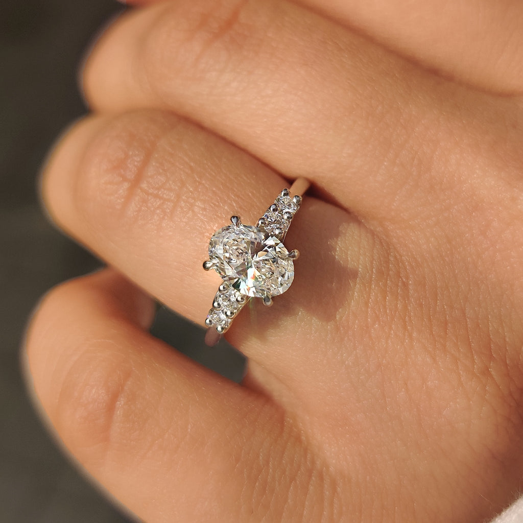 Oval Cut Diamond Ring with Round Side Stones