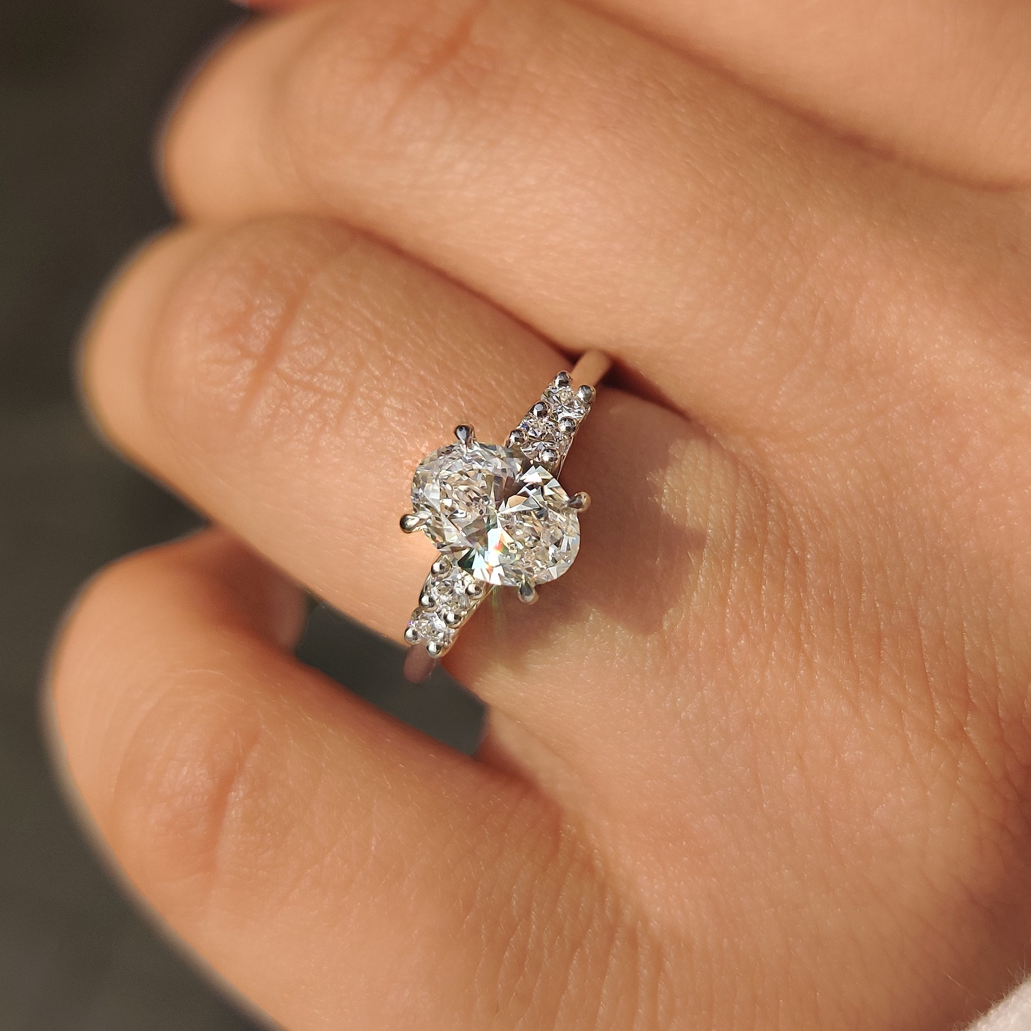 Oval Cut Diamond Ring with Round Side Stones