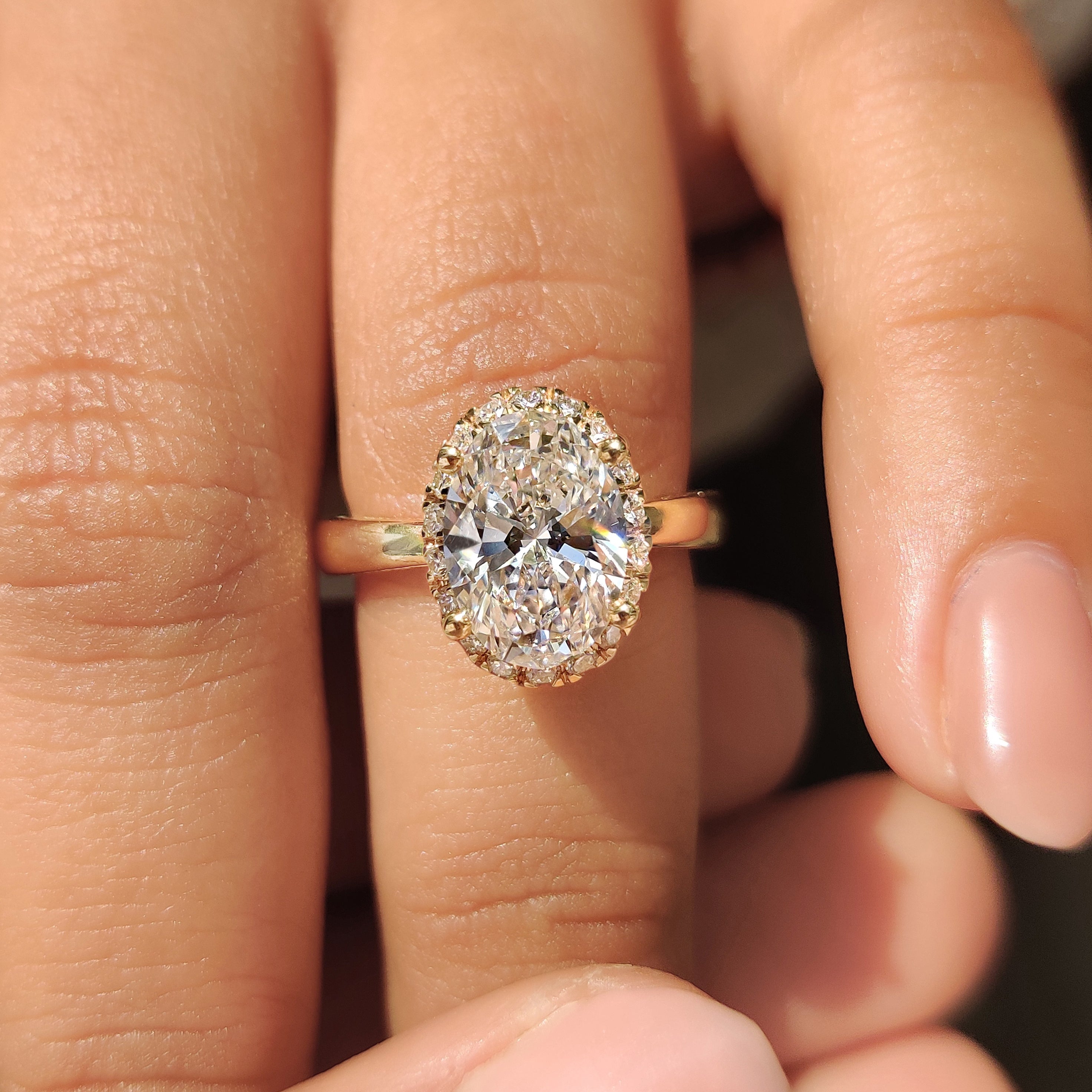 Oval Cut Diamond Ring in Round Cut Diamond Basket Setting Secondary image