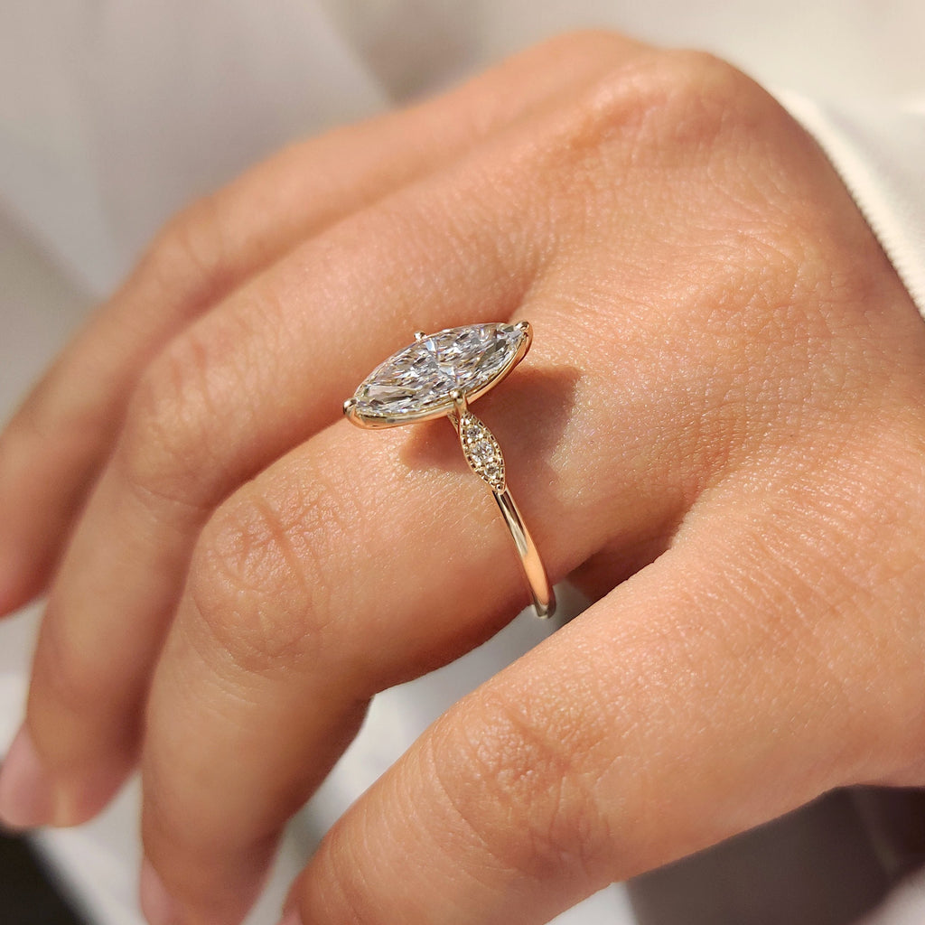 Marquise Cut Diamond Ring with Round Side Stones