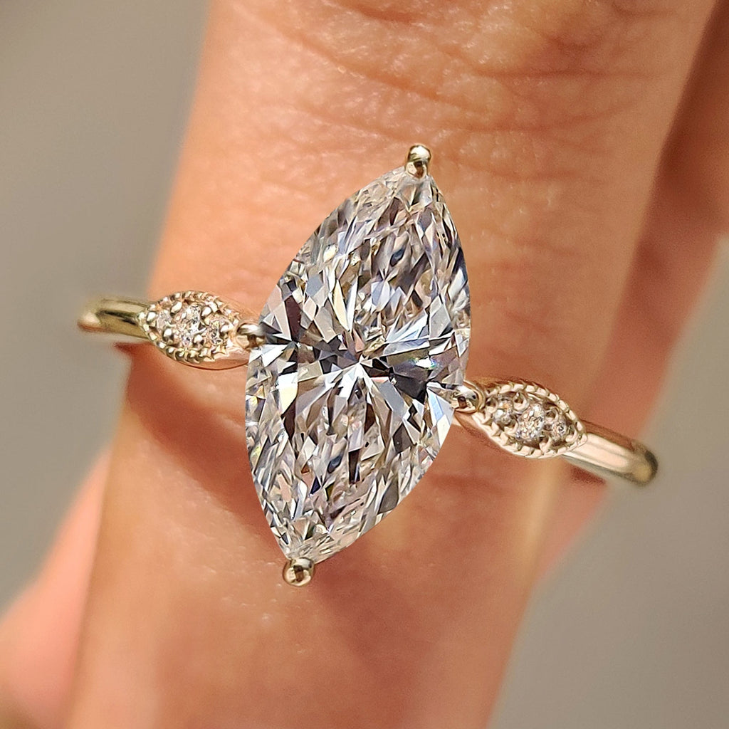 Marquise Cut Diamond Ring with Round Side Stones