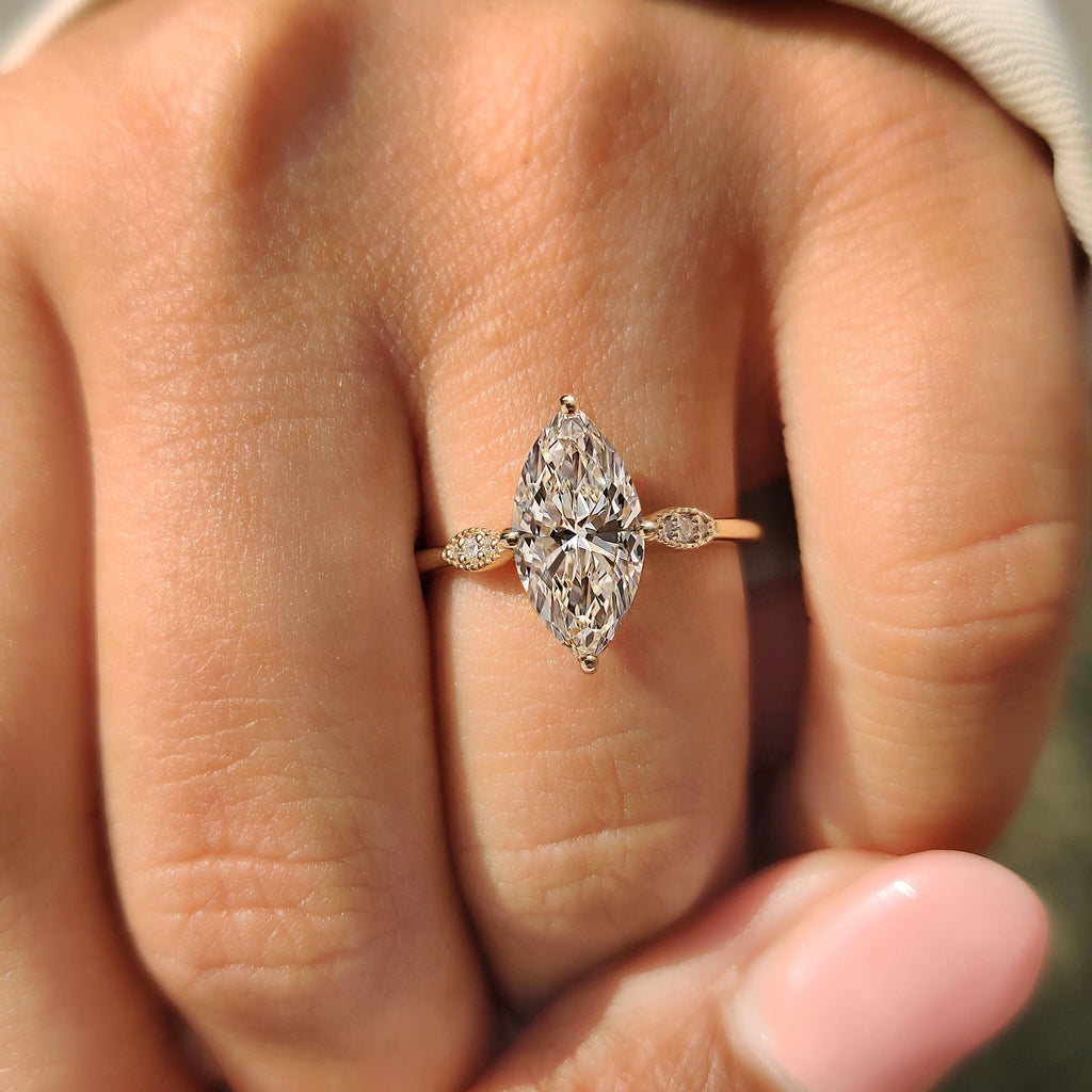 Marquise Cut Diamond Ring with Round Side Stones