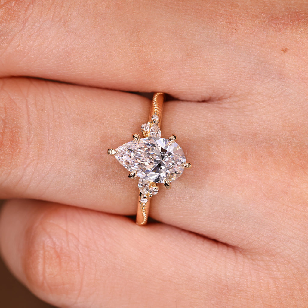 Pear Cut Engagement Ring With Side Stone In Vintage Style