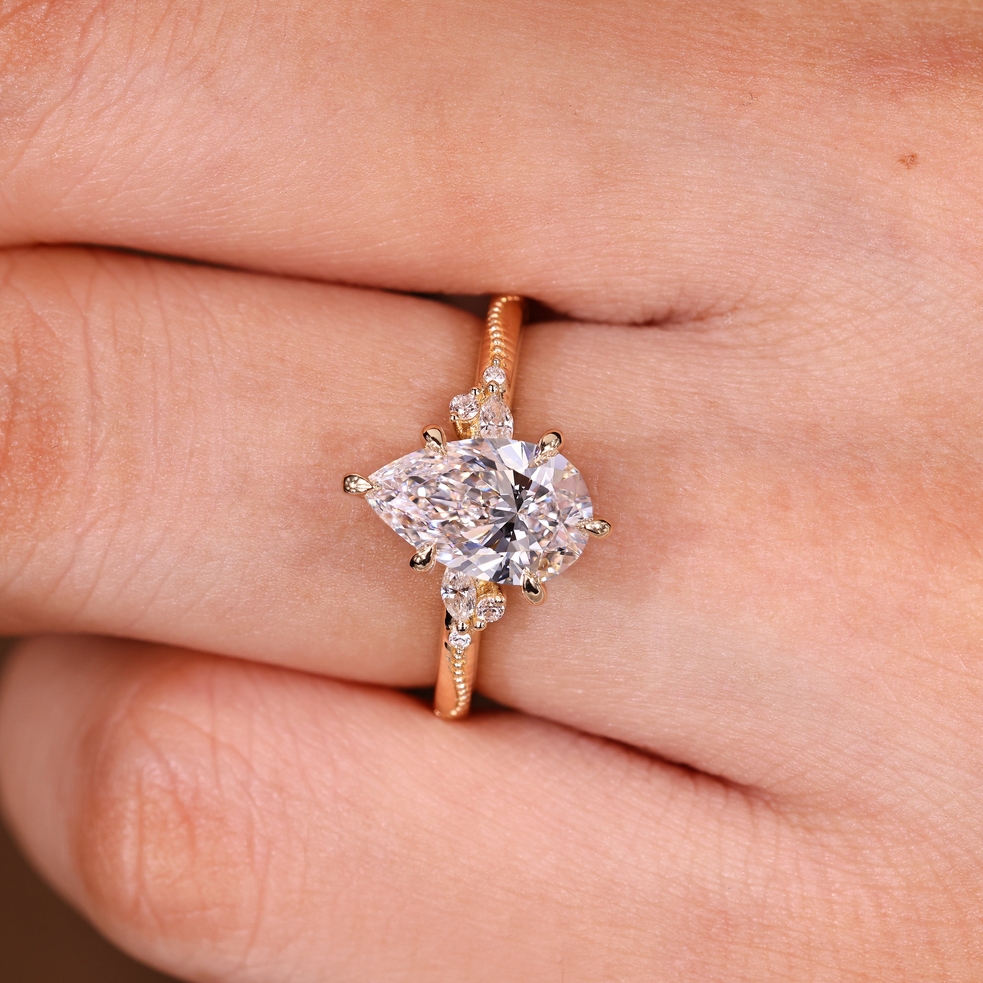 Pear Cut Engagement Ring With Side Stone In Vintage Style