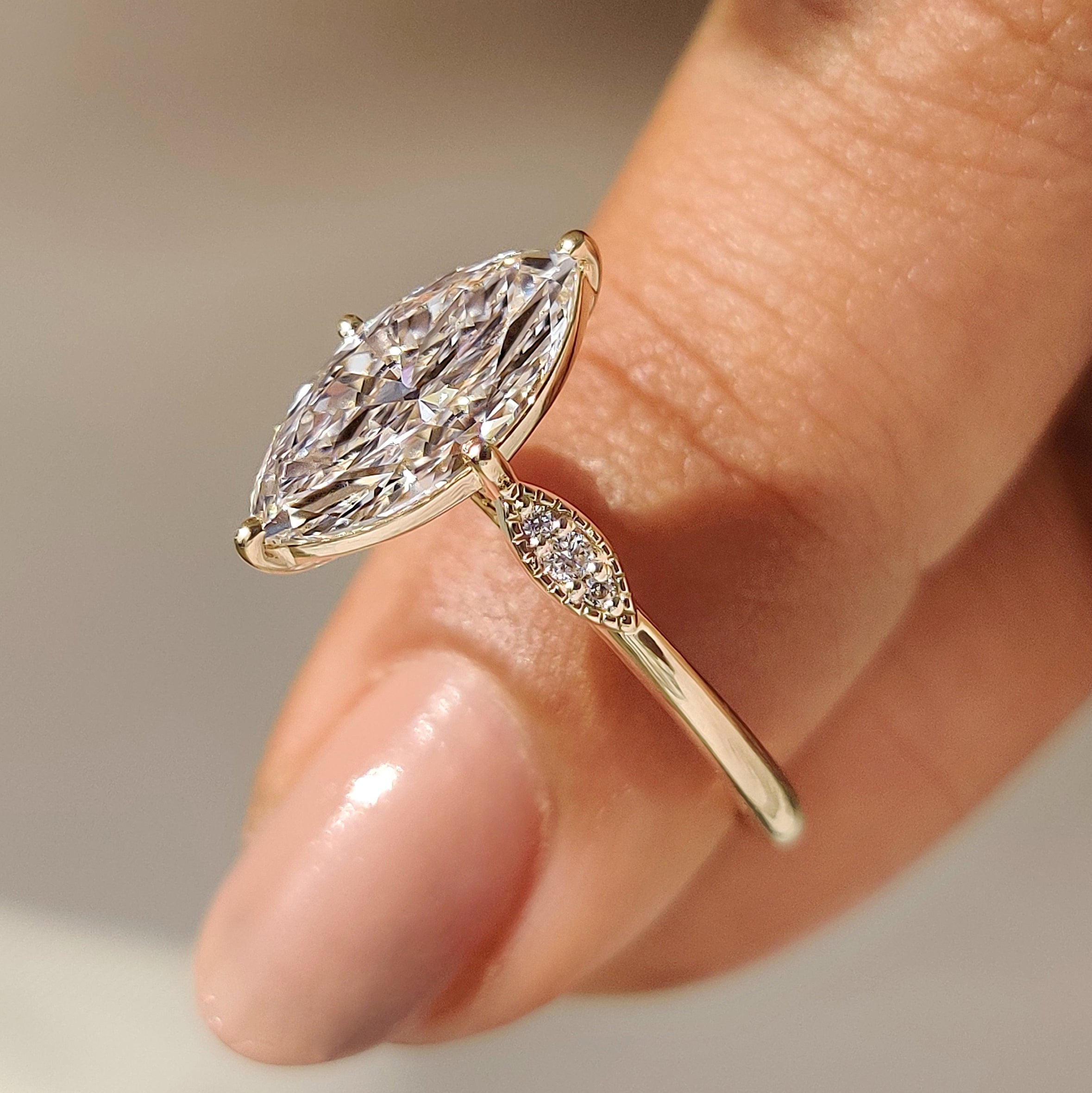 Marquise Cut Diamond Ring with Round Side Stones