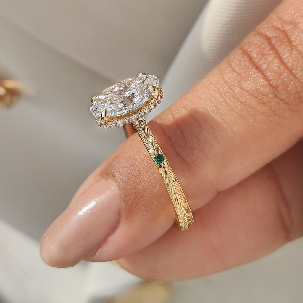Oval Cut Art Deco Diamond Ring with Two Emerald Side Gemstones