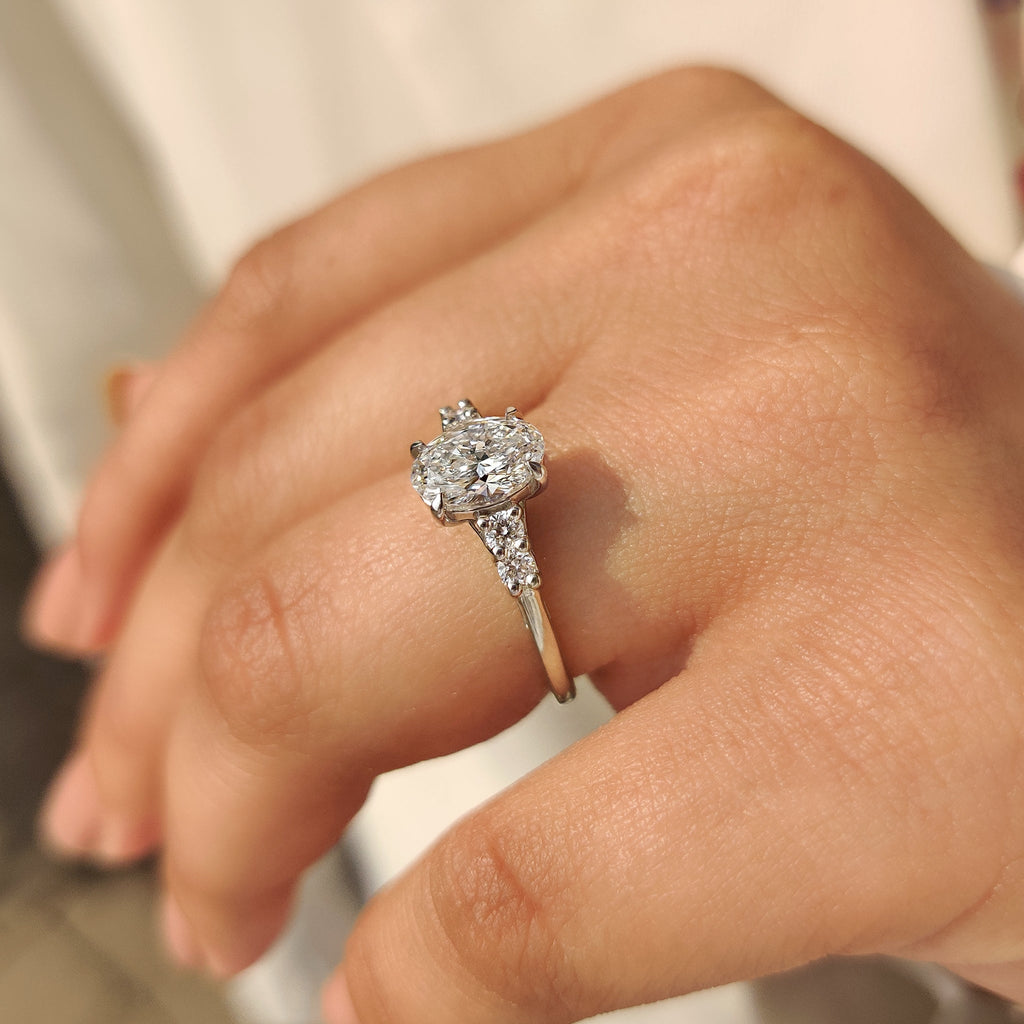 Oval Cut Diamond Ring with Round Side Stones