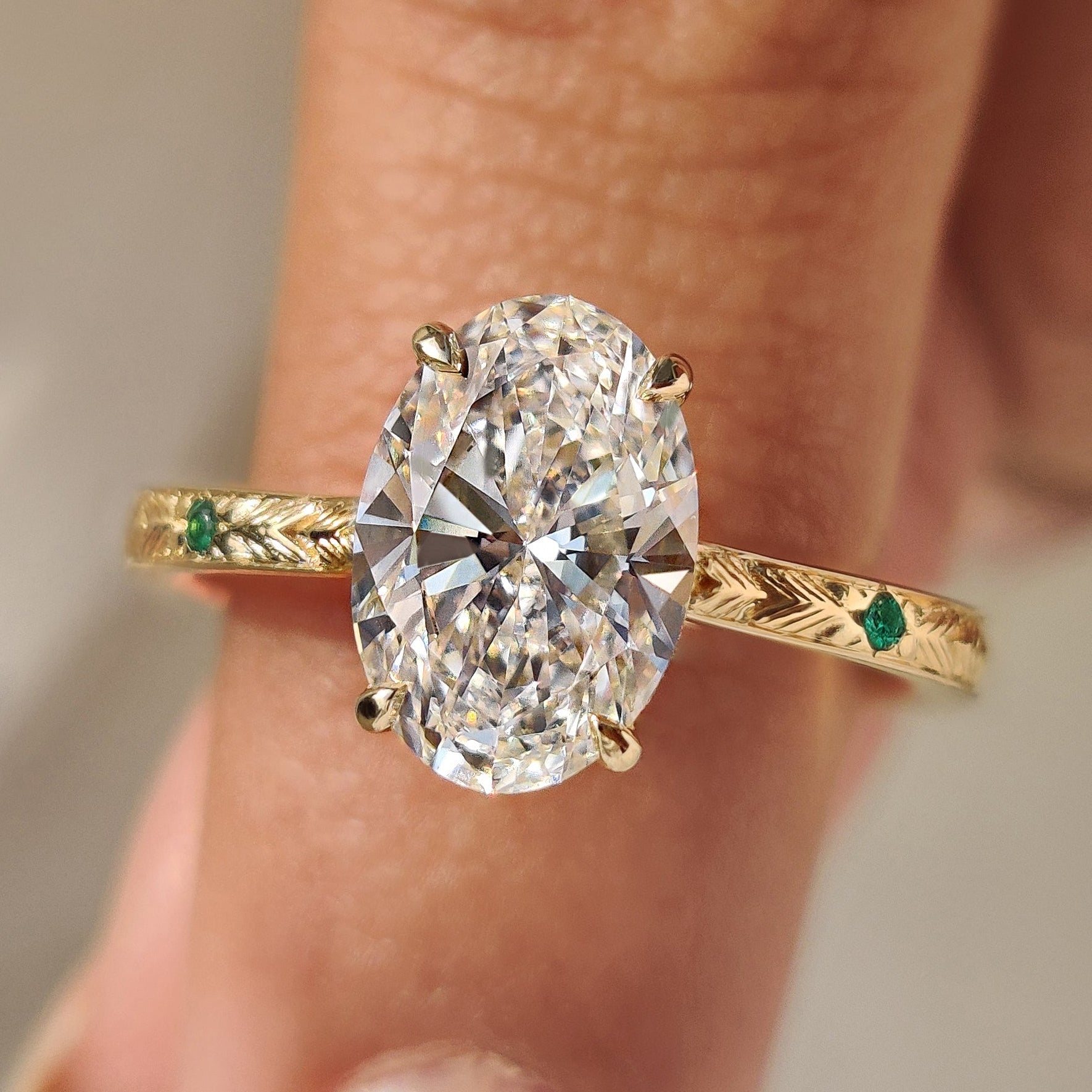 Oval Cut Art Deco Diamond Ring with Two Emerald Side Gemstones Main image